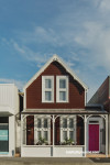 brown house, brown exterior, brown cottage, pink front door, 1800s cottage, resene brown pod